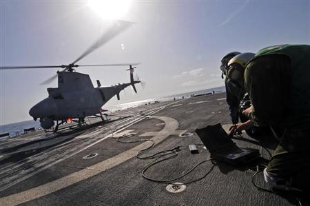 U.S. Navy Aviation Electronics Technician Erminger and Aviation Machinist's Mate Moody prepare to launch an MQ-8B Fire Scout unmanned aerial vehicle during flight operations aboard guided missile frigate USS Simpson in the Gulf of Guinea in this handout p